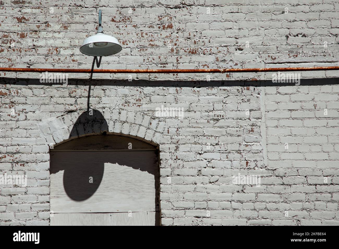 Brick wall with a lamp and copy space Stock Photo