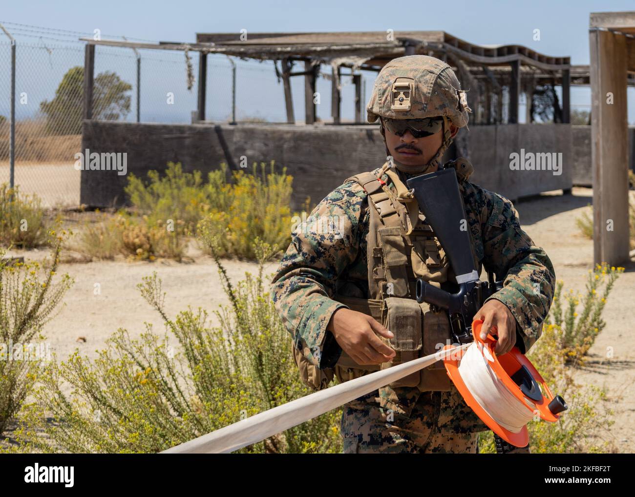 MARINE CORPS BASE CAMP PENDLETON, California (Sept. 2, 2022) - U.S. Marine Corps Cpl. Deether Edralin, a searching NCO with Combat Logistic Battalion 13, 13th Marine Expeditionary Unit, sets up engineer tape in preparation for an Evacuation Control Center exercise. A force in readiness, the 13th MEU trains to rapidly respond to crises across all domains. Marines and Sailors of the 13th MEU are embarked aboard the Makin Island Amphibious Ready Group (ARG) conducting integrated training operations in U.S. 3rd Fleet. Stock Photo