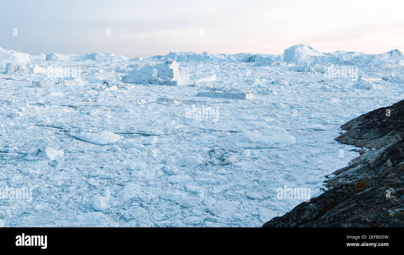 Global warming and climate change concept. Iceberg aerial drone image of giant icebergs in Disko Bay on greenland in Ilulissat icefjord from melting Stock Photo