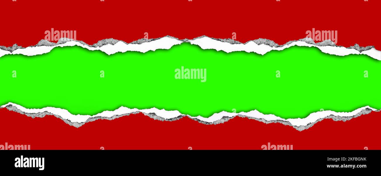Hole ripped in red paper on green. Christmas background. Copy space Stock Photo