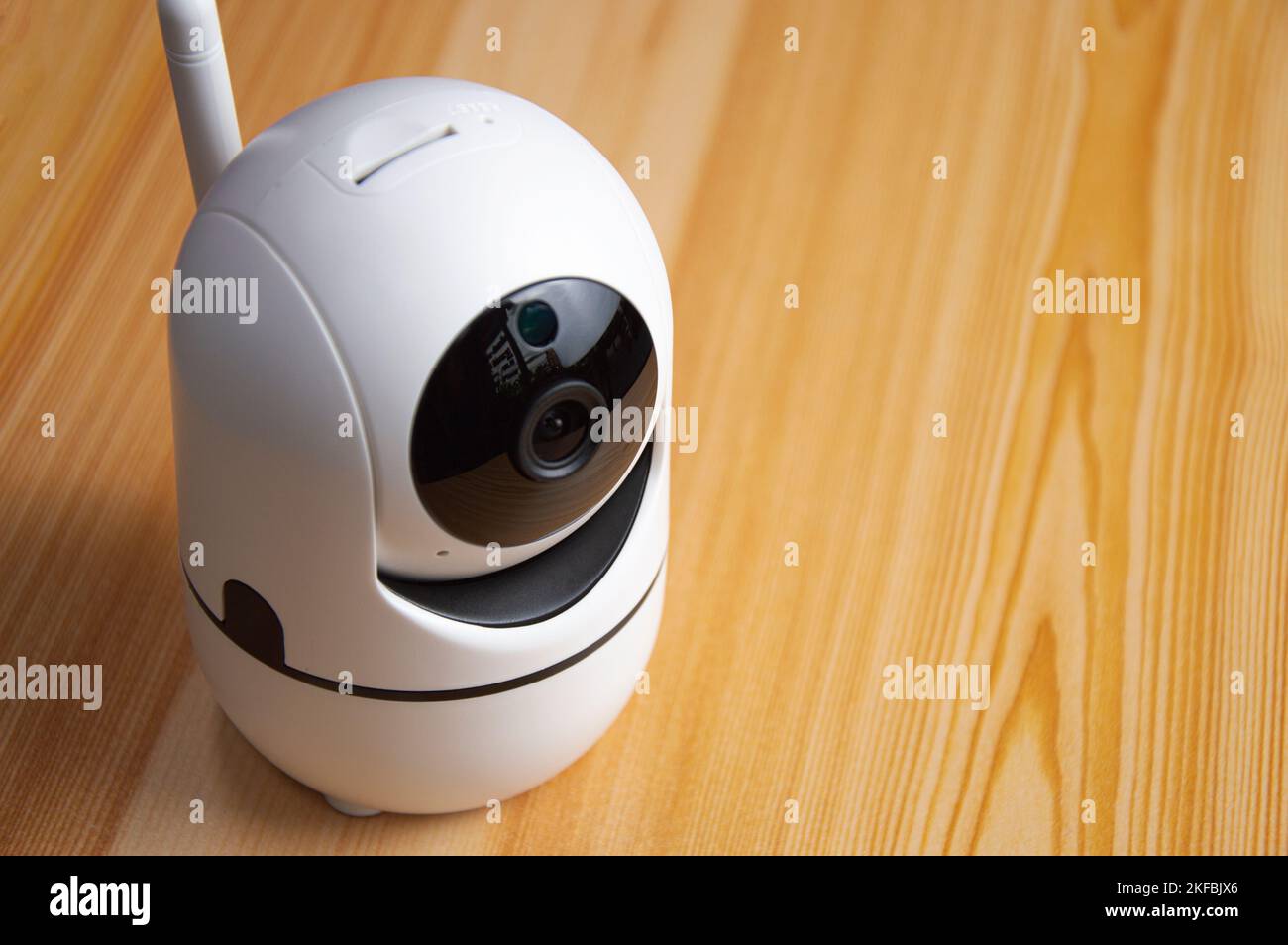 White IP camera placed on wooden floor Stock Photo