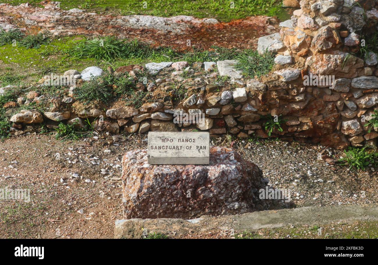 Marble marker identifying the Sanctuary of Pan that contains a small cave shrine dedicated to the mountain god, Pan and his nymphs Athens Greece 01 02 Stock Photo