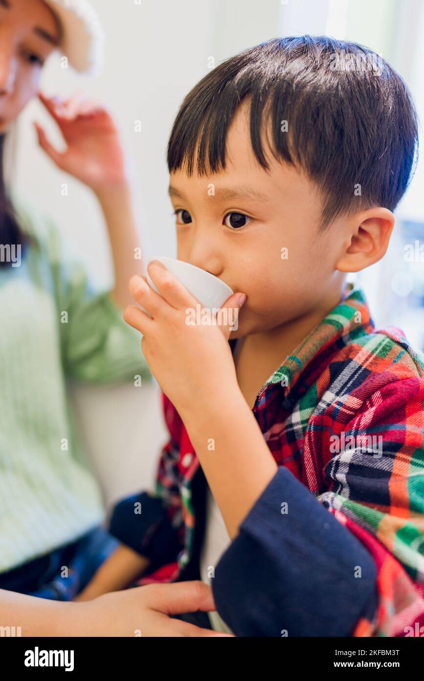 A boy drinking a cup of Japanese tea Stock Photo