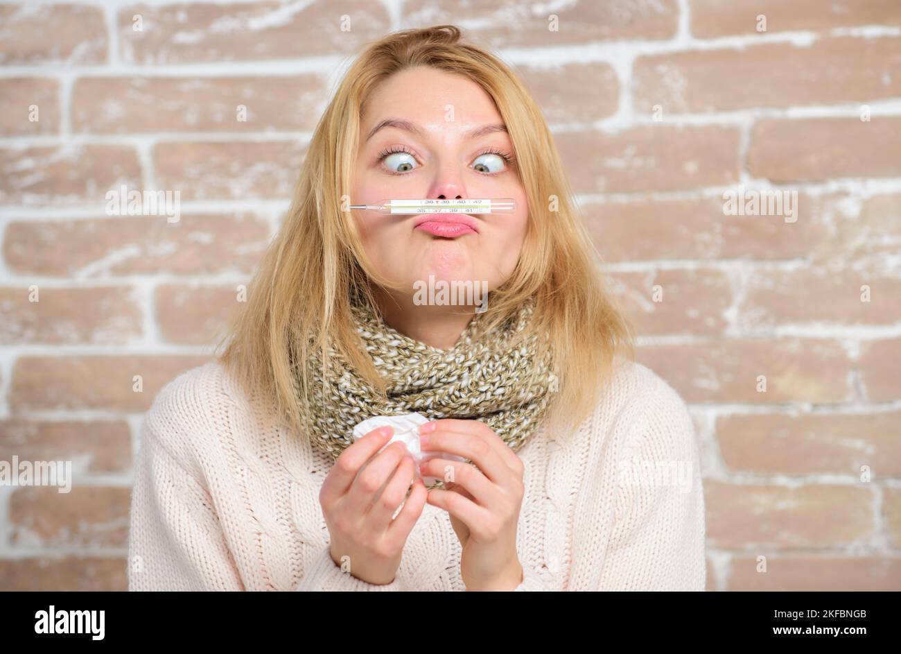 Girl hold thermometer and tissue. Measure temperature. Break fever