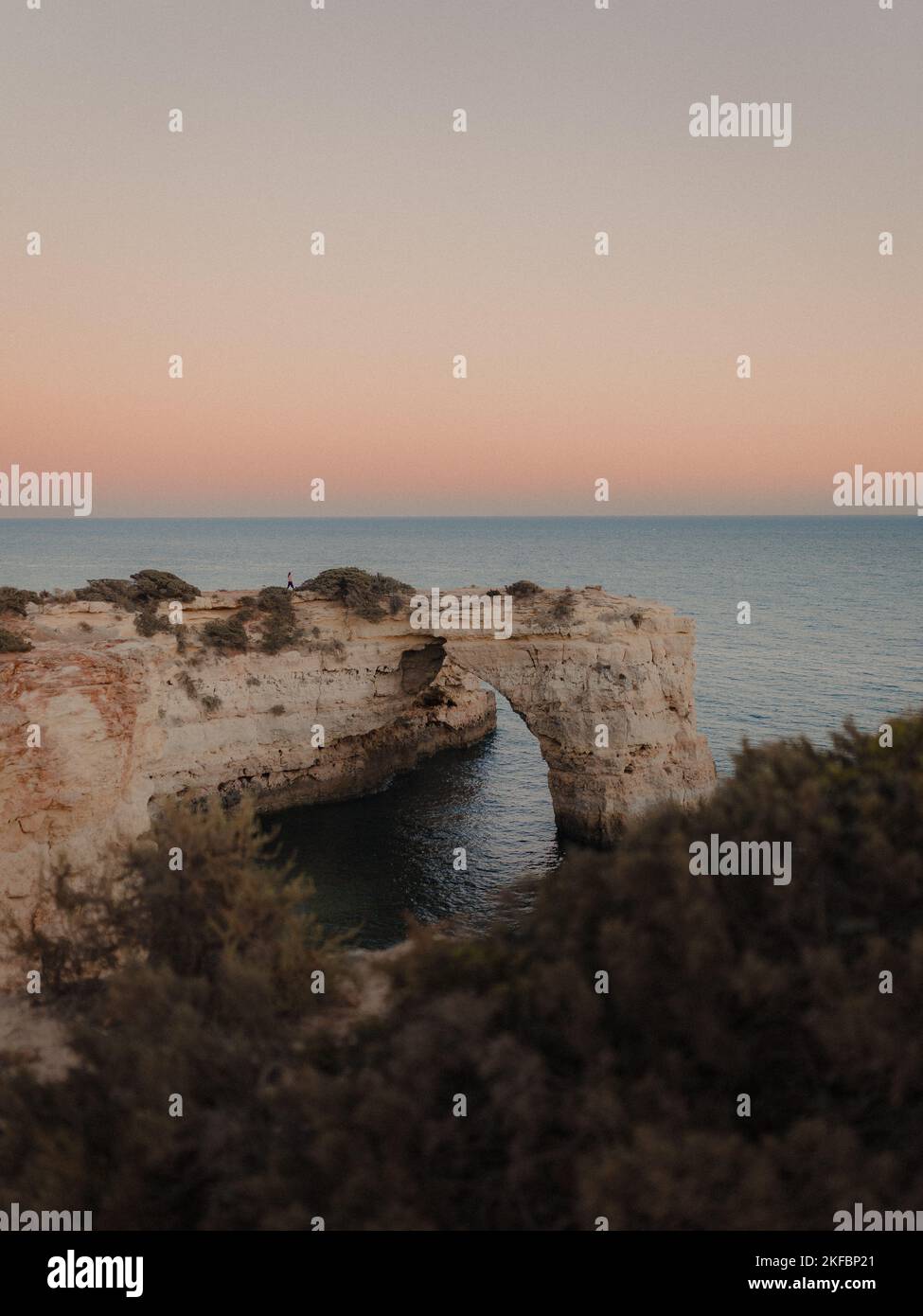 A beautiful view of the Arco De Albandeira, Algarve, Portugal at sunset