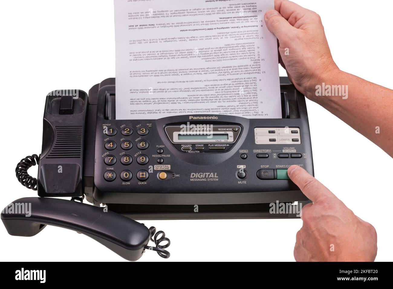Close up view of person's hands sending fax on Panasonic fax phone. Sweden. Stock Photo