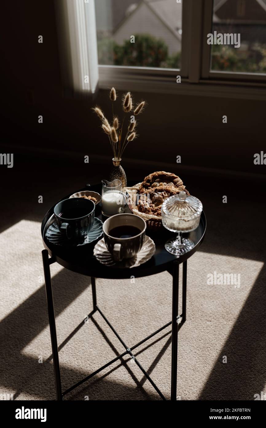 Aesthetic breakfast. Milk coffee, milk tea, sugar, almond, almond cakes, biscuits, marzipans and puffs. British breakfast in a cozy home. Autumn mood. Stock Photo