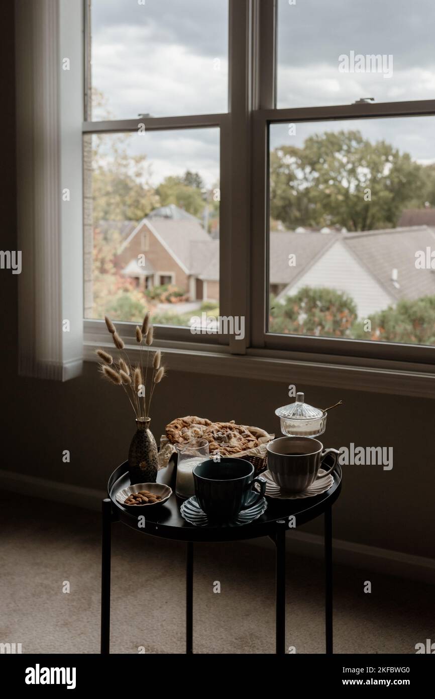 Aesthetic breakfast. Milk coffee, milk tea, sugar, almond, almond cakes, biscuits, marzipans and puffs. British breakfast in a cozy home. Autumn mood. Stock Photo