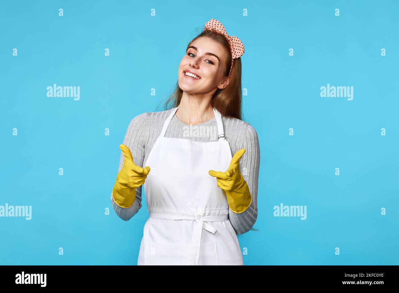 woman in rubber gloves and cleaner apron pointing fingers to camera ...
