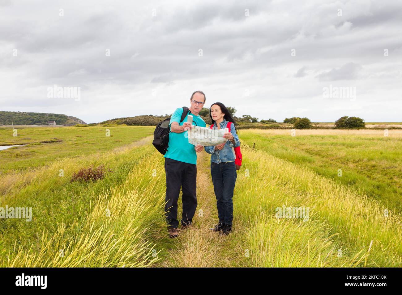 Mature couple in countryside, reading Ordnance Survey map Stock Photo