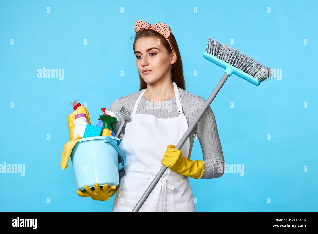 woman in gloves holding bucket of detergents and broom Stock Photo - Alamy