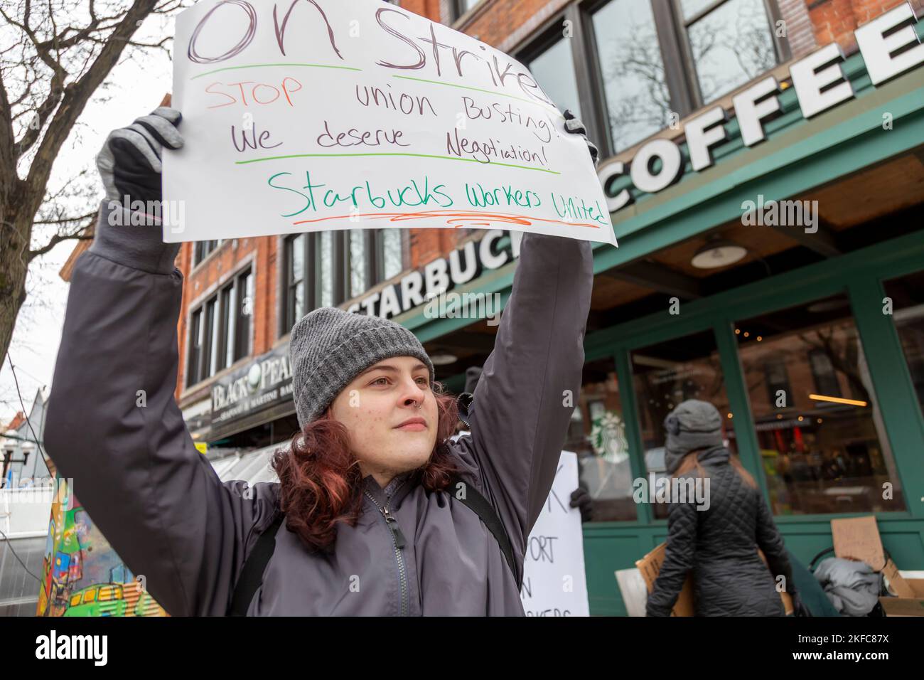 Ann Arbor, Michigan, USA. 17th Nov, 2022. Starbucks workers on strike at a Starbucks Coffee shop. Workers at this store were among more than 100 stores nationwide participating in an unfair labor practice strike over inadequate staffing on the company's Red Cup Day. They are members of the Starbucks Workers United union. Credit: Jim West/Alamy Live News Stock Photo