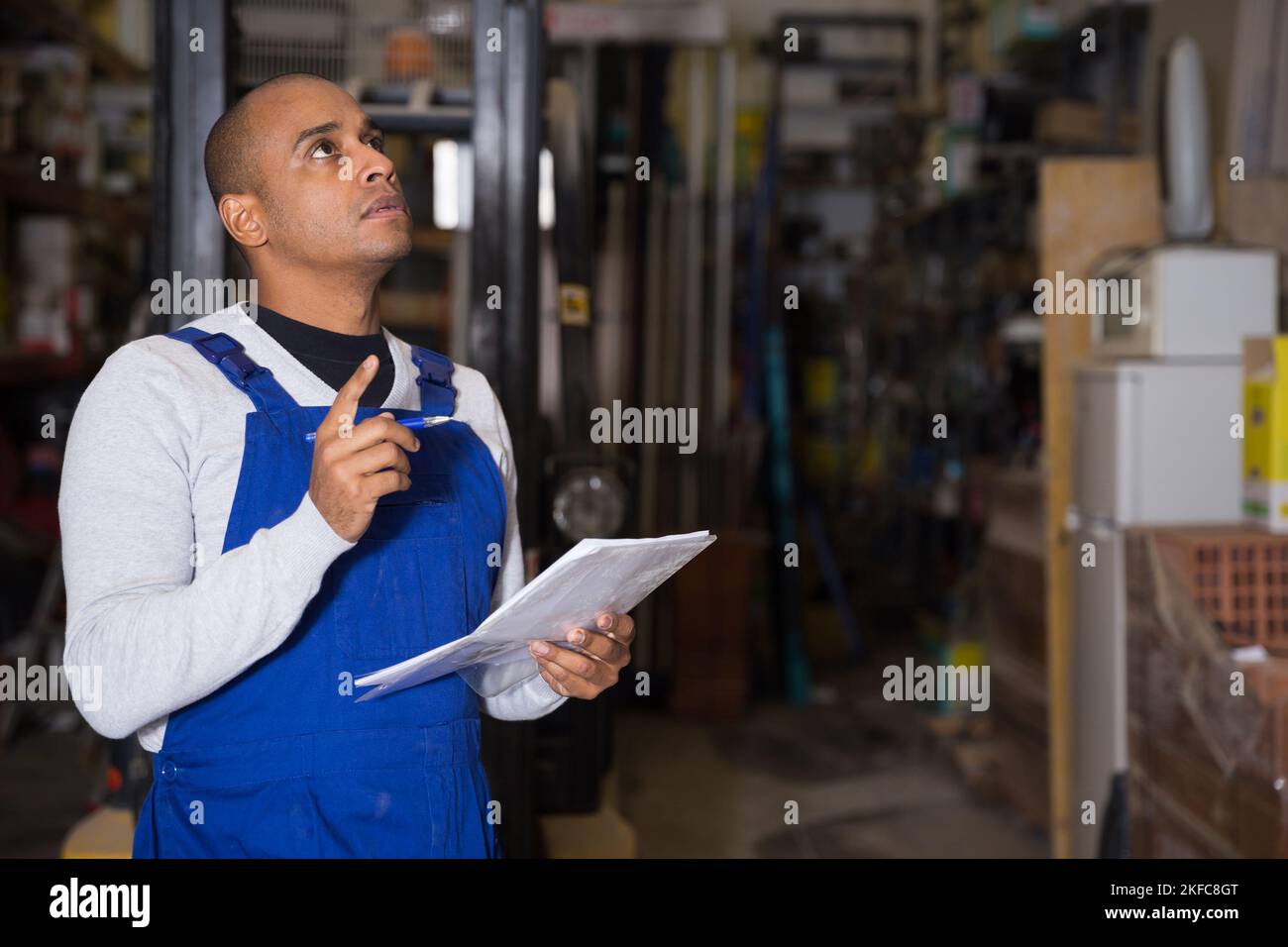 Confident worker taking inventory in building materials store Stock Photo