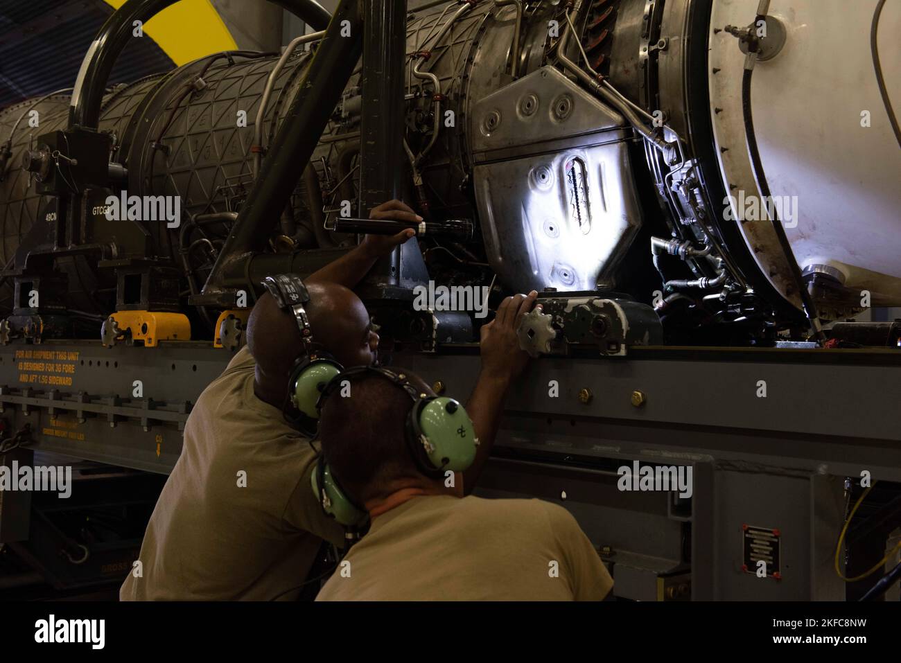 U.S. Air Force Staff Sgt. Samuel Berry, 49th Component Maintenance Squadron test cell craftsman, and Senior Airman Alex Turnage, 49th Component Maintenance Squadron aerospace propulsion journeyman, inspect the oil on a Pratt & Whitney F100 turbofan engine at Holloman Air Force Base, New Mexico, Sept. 6, 2022. The 49th CMS is composed of more than 190 personnel charged with providing top-tier engines that keep Holloman's F-16 Viper pilots in the air. Stock Photo