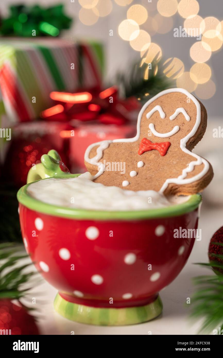 Gingerbread cookie man in a hot cup of cappuccino Stock Photo