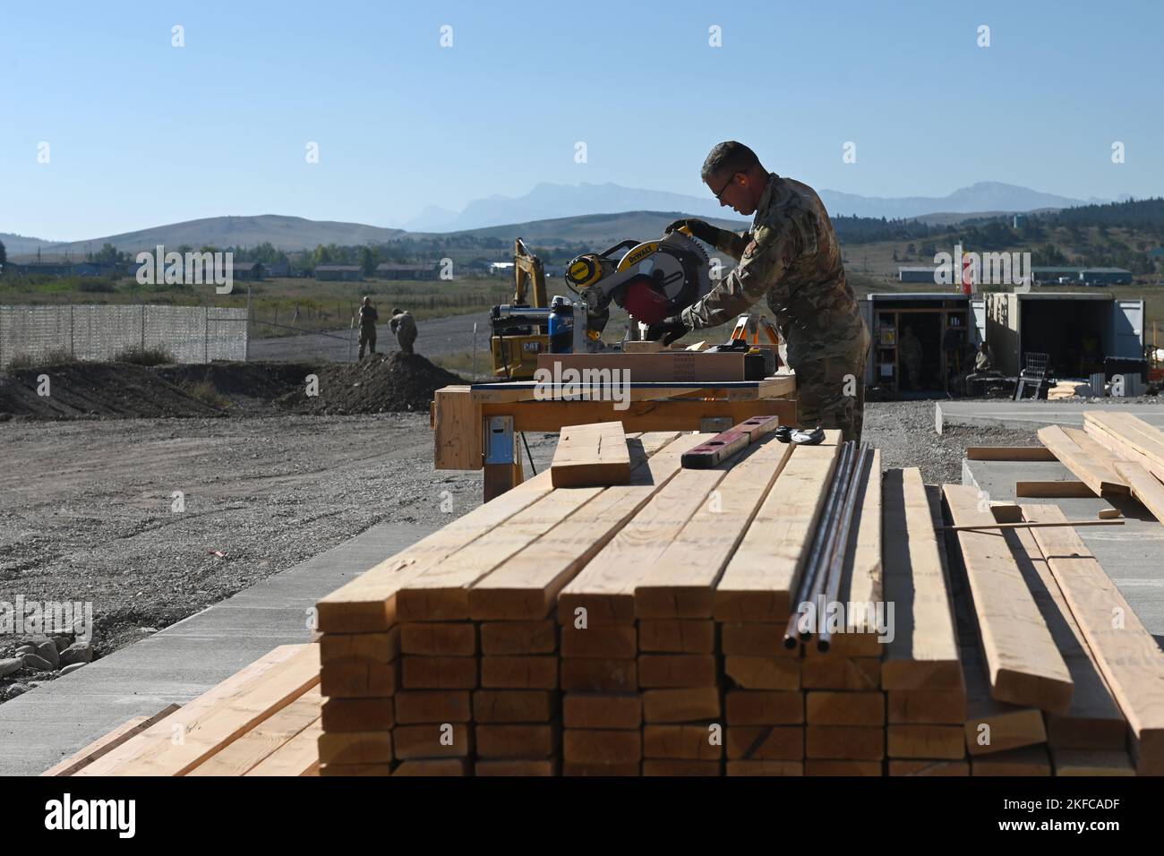 U.S. Air Force Tech. Sgt. Matthew Hamilton, 169th Civil Engineer Squadron engineer from the South Carolina Air National Guard, uses a miter saw during construction of a community center for the Blackfeet Nation Native Americans at Heart Butte, Montana, September 6, 2022. This temporary deployment is part of the 169th Civil Engineer Squadron’s yearly Innovative Readiness Training (IRT) that helps Airmen train in a real-world environment to acquire and maintain their trade skills. Stock Photo