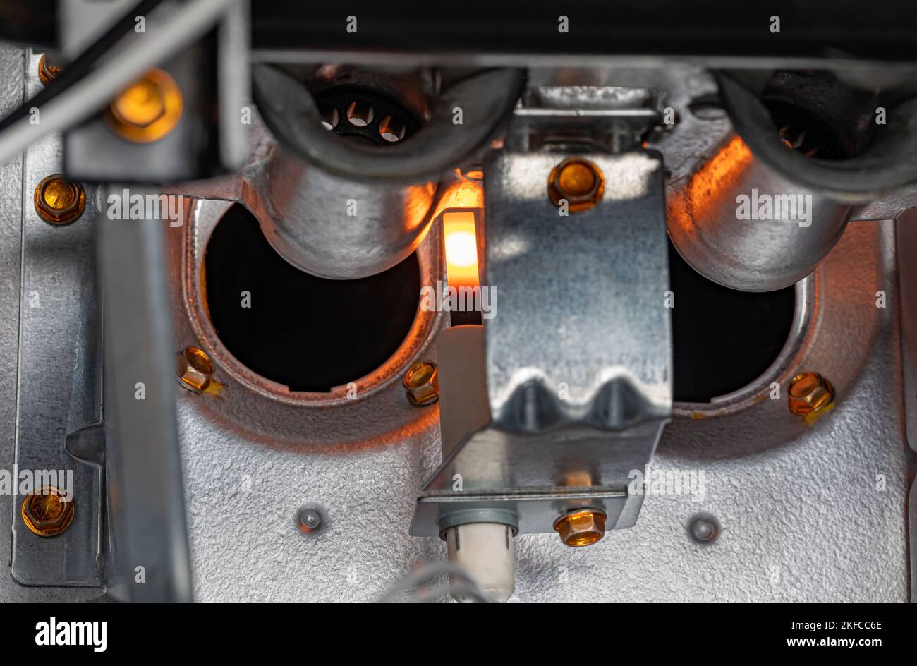 Gas furnace flame ignitor glowing and ready to ignite gas. HVAC maintenance, repair, service and