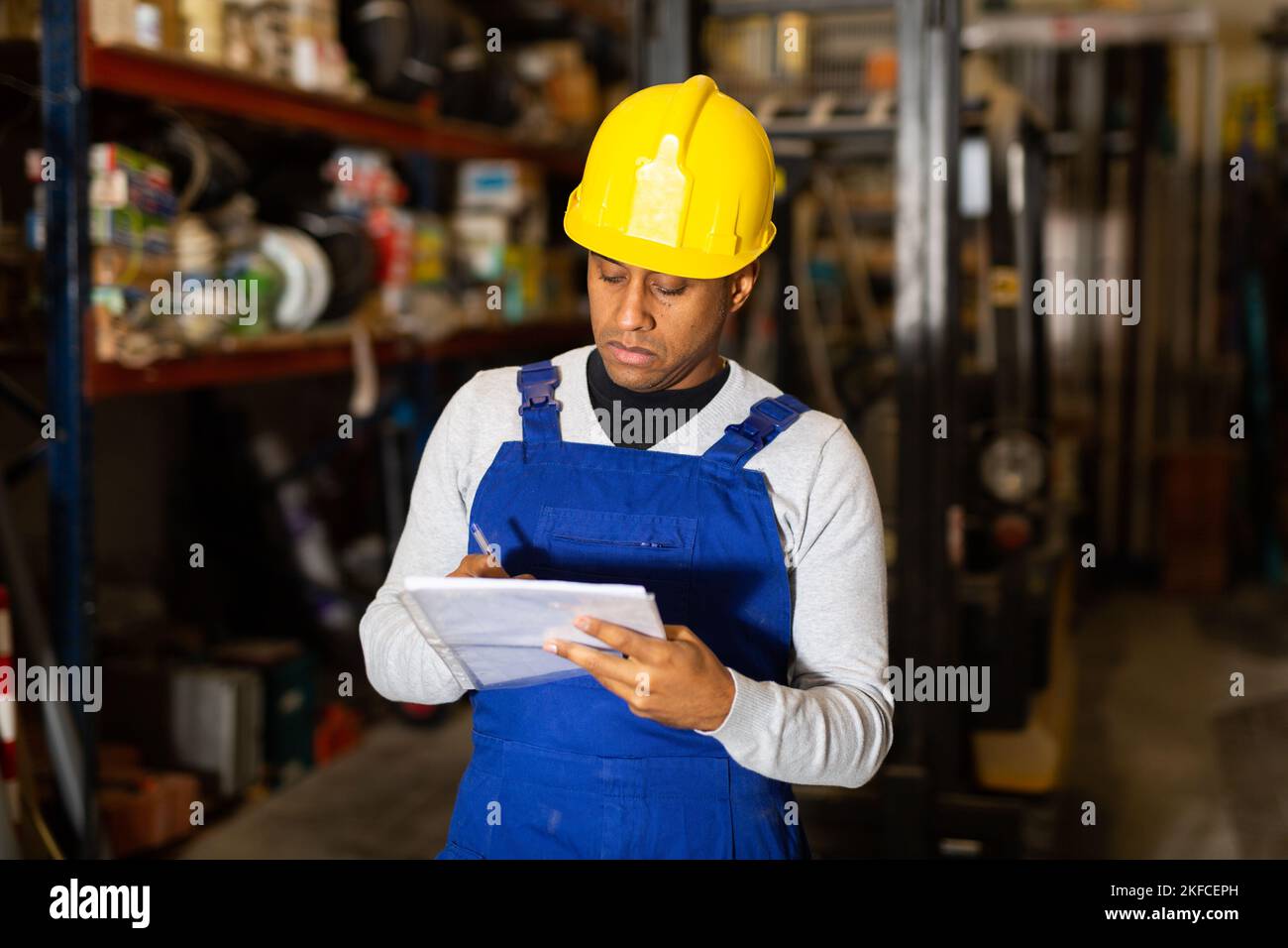 Confident worker taking inventory in building materials store Stock Photo
