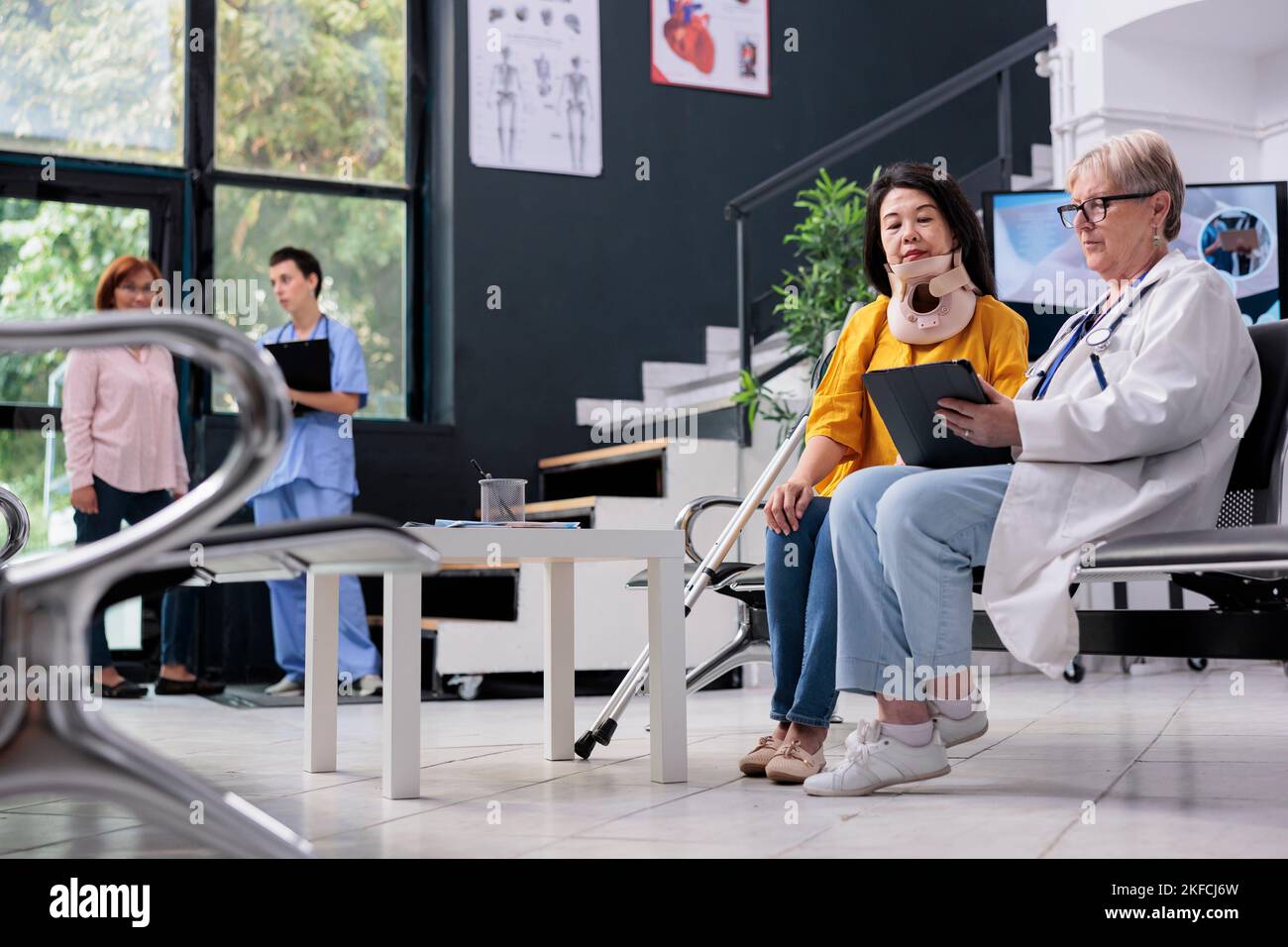 Senior specialist consulting patient with cervical neck collar using