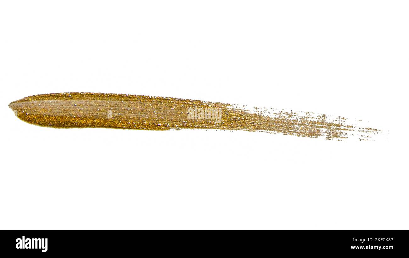 Brush stroke of golden paint with sparkles on a white background. Stock Photo