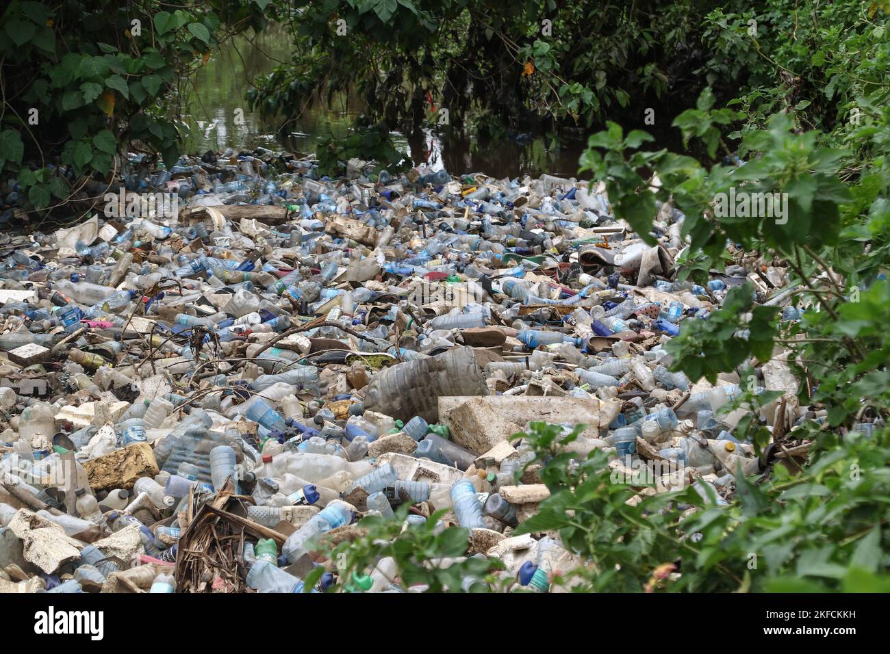 A view of a river heavily polluted with plastic drinks bottles in ...