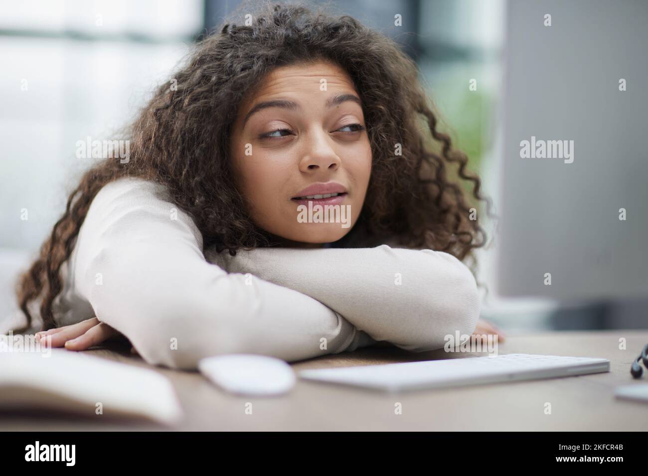 Portrait of a beautiful business woman sleeping on the table in the