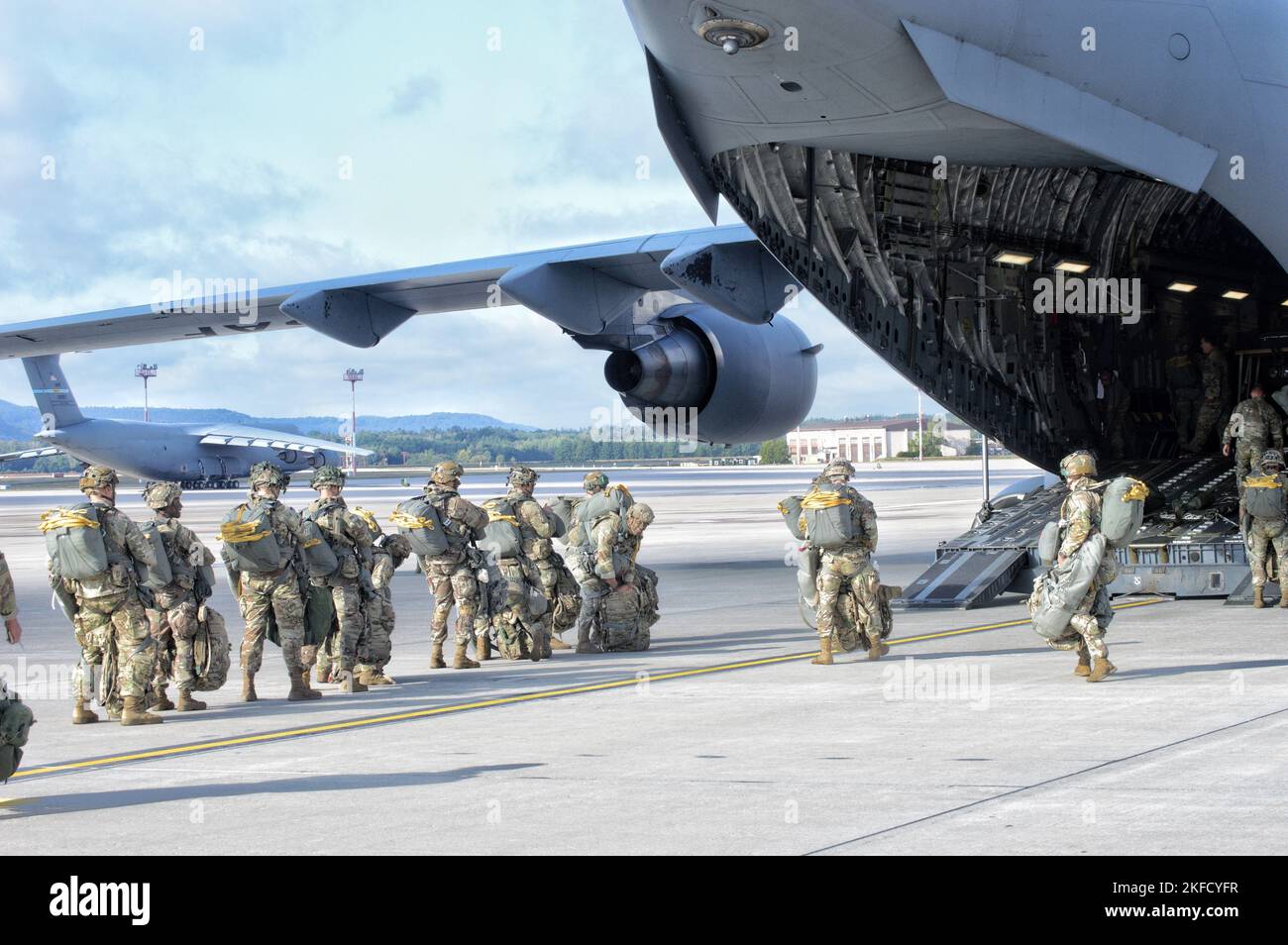 U.S. Army soldiers assigned to the 173rd Airborne Brigade load a C-17 ...