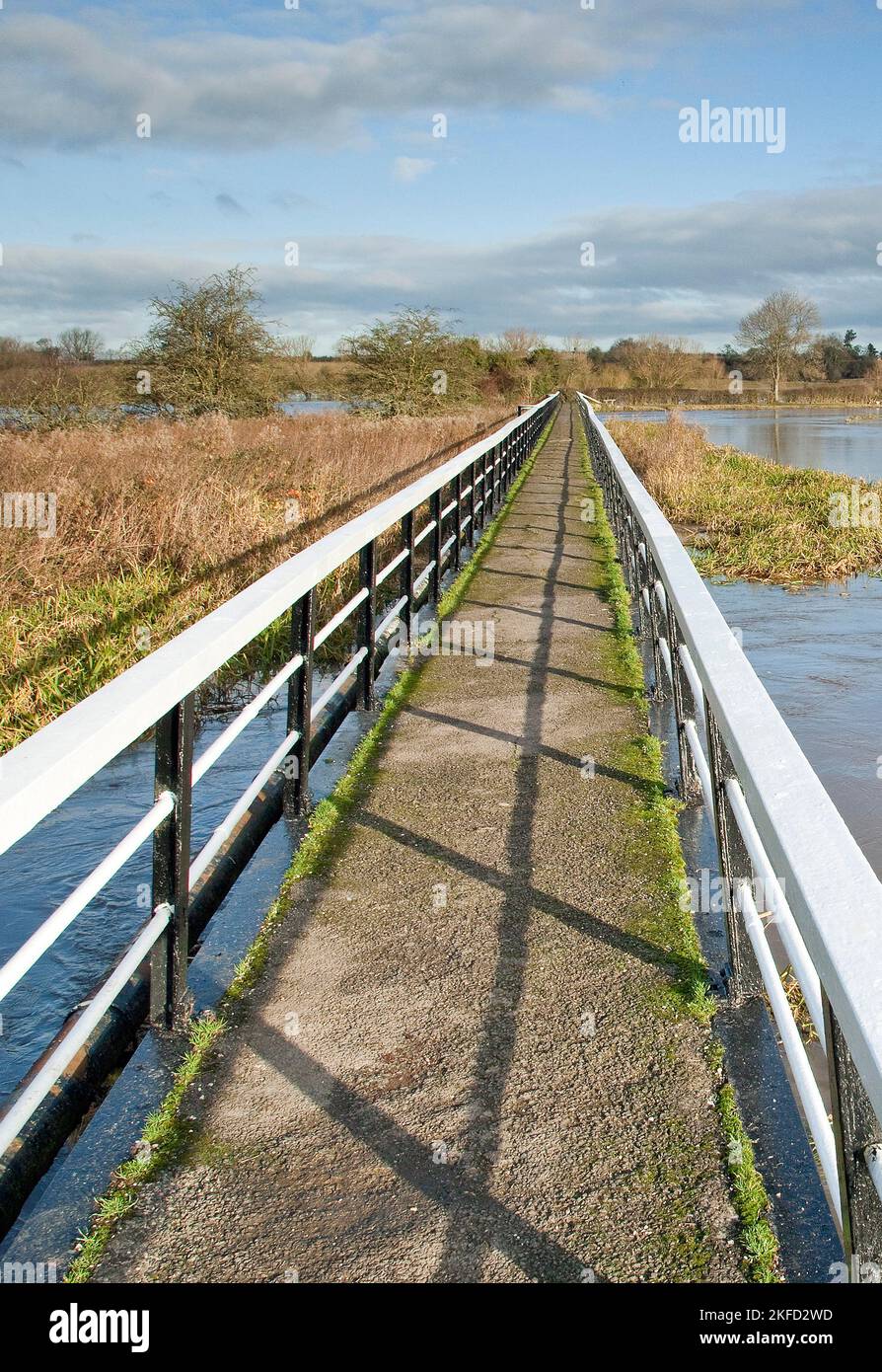 Footbridge over severe flooding from the rising river trent in Alrewas