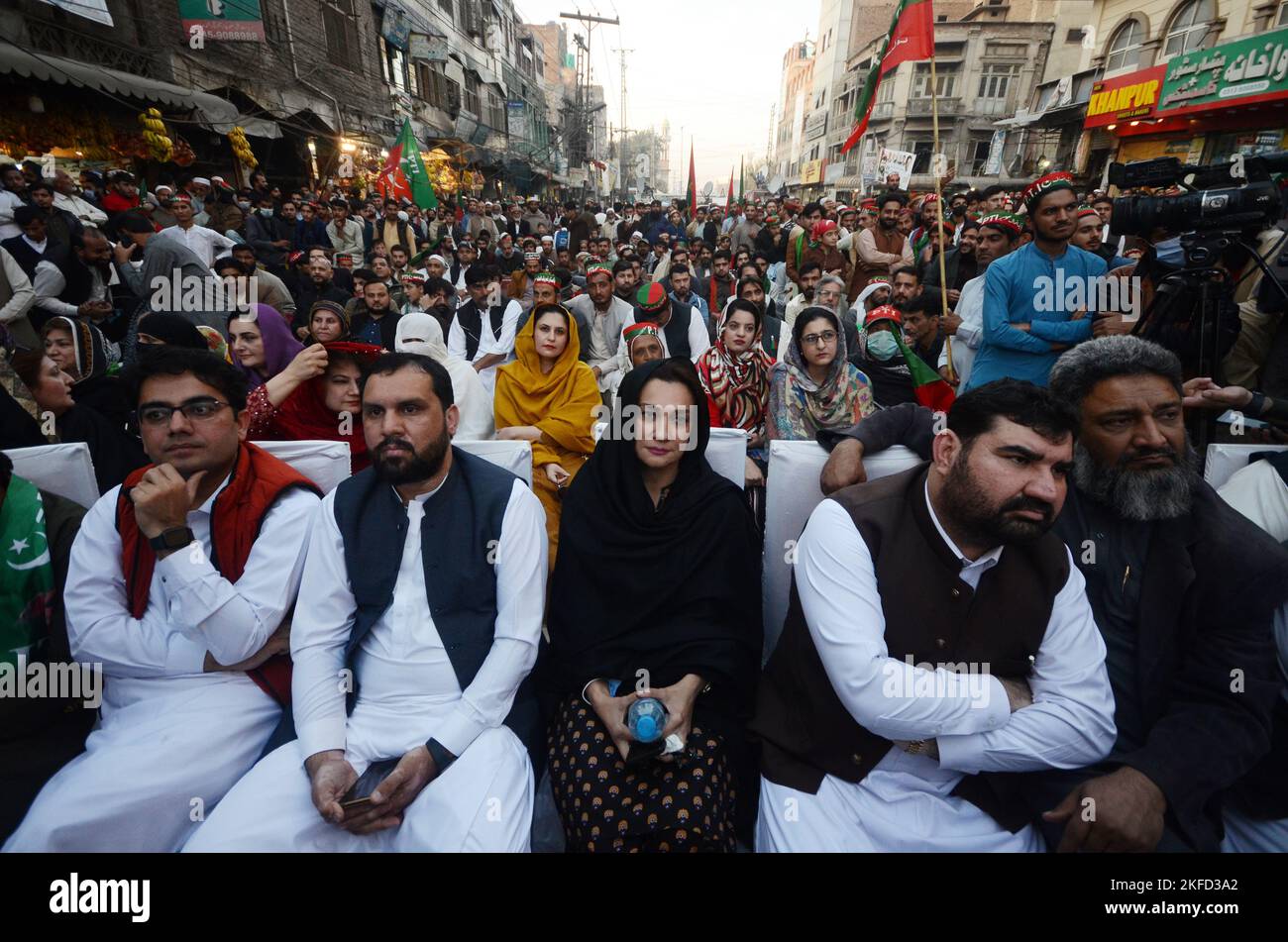 Peshawar, Khyber Pakhtunkhwa, Pakistan. 17th Nov, 2022. Supporters watch a video-linked address of former Prime Minister Imran Khan, head of the Pakistan Tehrik-e-Insaf (PTI) party, as the protest march continues followings its resumption, days after an assassination attempt on the former prime minister halted the rally at G T Road in Peshawar. The march to the capital Islamabad resumed from eastern Punjab Wazirabad city, as Khan keeps pressing for snap elections, a demand rejected by the government of Prime Minister Sharif. The Tehreek-e-Insaf party began its march from Lahore in late Octo Stock Photo