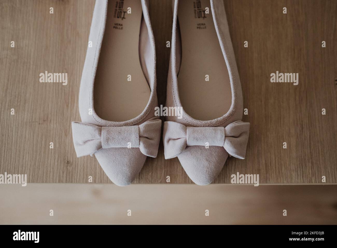 A top view of a pair of creamy bridal shoes on the table Stock Photo
