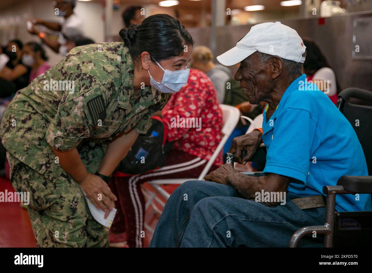 Cartagena, Colombia. 12th Nov, 2022. Lt. Cmdr. Ruby Jackson, assigned to the hospital ship USNS Comfort (T-AH 20), talks with a patient during the ship's patient intake process in Cartagena, Colombia, November. 12, 2022. Comfort is deployed to U.S. 4th Fleet in support of Continuing Promise 2022, a humanitarian assistance and goodwill mission conducting direct medical care, expeditionary veterinary care, and subject matter expert exchanges with five partner nations in the Caribbean, Central and South America. Credit: U.S. Navy/ZUMA Press Wire Service/ZUMAPRESS.com/Alamy Live News Stock Photo