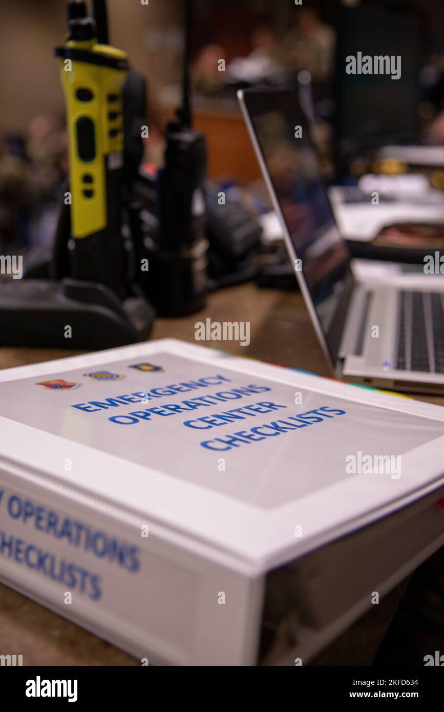 An emergency operations center checklist binder sits on a desk at the