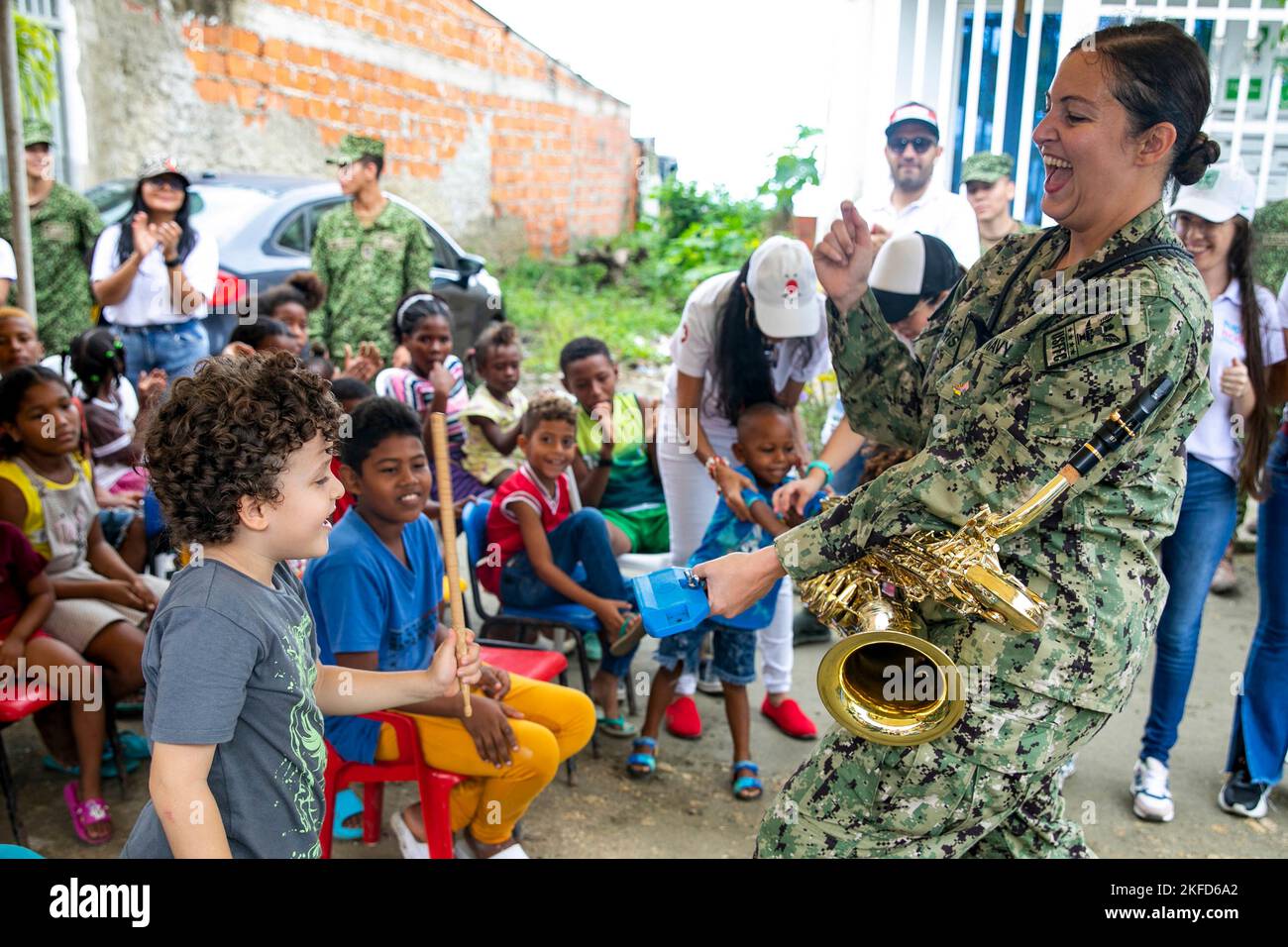 Cartagena, Colombia. 14th Nov, 2022. Musician 2nd Class Andrea Pharis, assigned to the U.S. Fleet Forces band and the hospital ship USNS Comfort (T-AH 20), plays the cowbell with a child from Fundacion Guerreros de Luz while performing in a concert in Cartagena, Colombia, November. 14, 2022. Comfort is deployed to U.S. 4th Fleet in support of Continuing Promise 2022, a humanitarian assistance and goodwill mission conducting direct medical care, expeditionary veterinary care, and subject matter expert exchanges with five partner nations in the Caribbean, Central and South America. (Credit Stock Photo