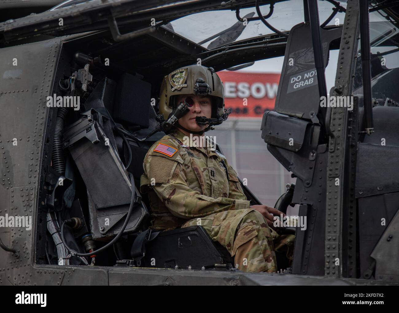 Dallas, Texas-native U.S. Army Capt. Mason Conine, an aviation officer, a part of Alpha Company, 1st Battalion (Attack), 3rd Aviation Regiment, 12th Combat Aviation Brigade, U.S. Army Europe and Africa, looks through his helmet-mounted display, the Integrated Helmet and Display Sighting System, from  the pilot's seat of his AH-64D Apache attack helicopter during the 30th annual International Defense Industry Exhibition (MSPO) at Kielce, Poland, Sept. 8, 2022. More than 185 defense industry exhibitors from more than 15 countries participated in MSPO—an international exhibition designed to showc Stock Photo