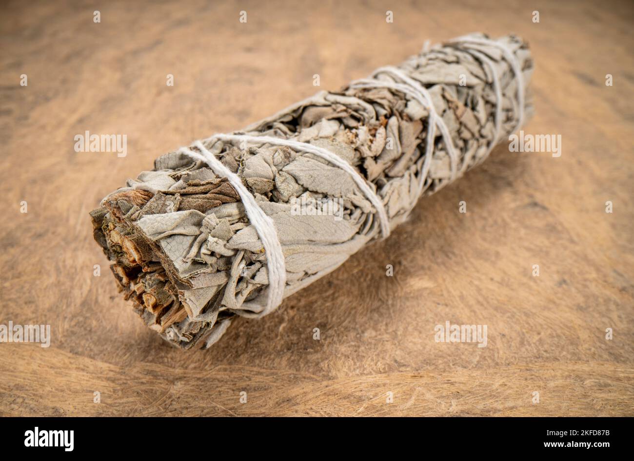 white sage incense bundle on a textured bark paper, macro shot, aromatherapy concept Stock Photo