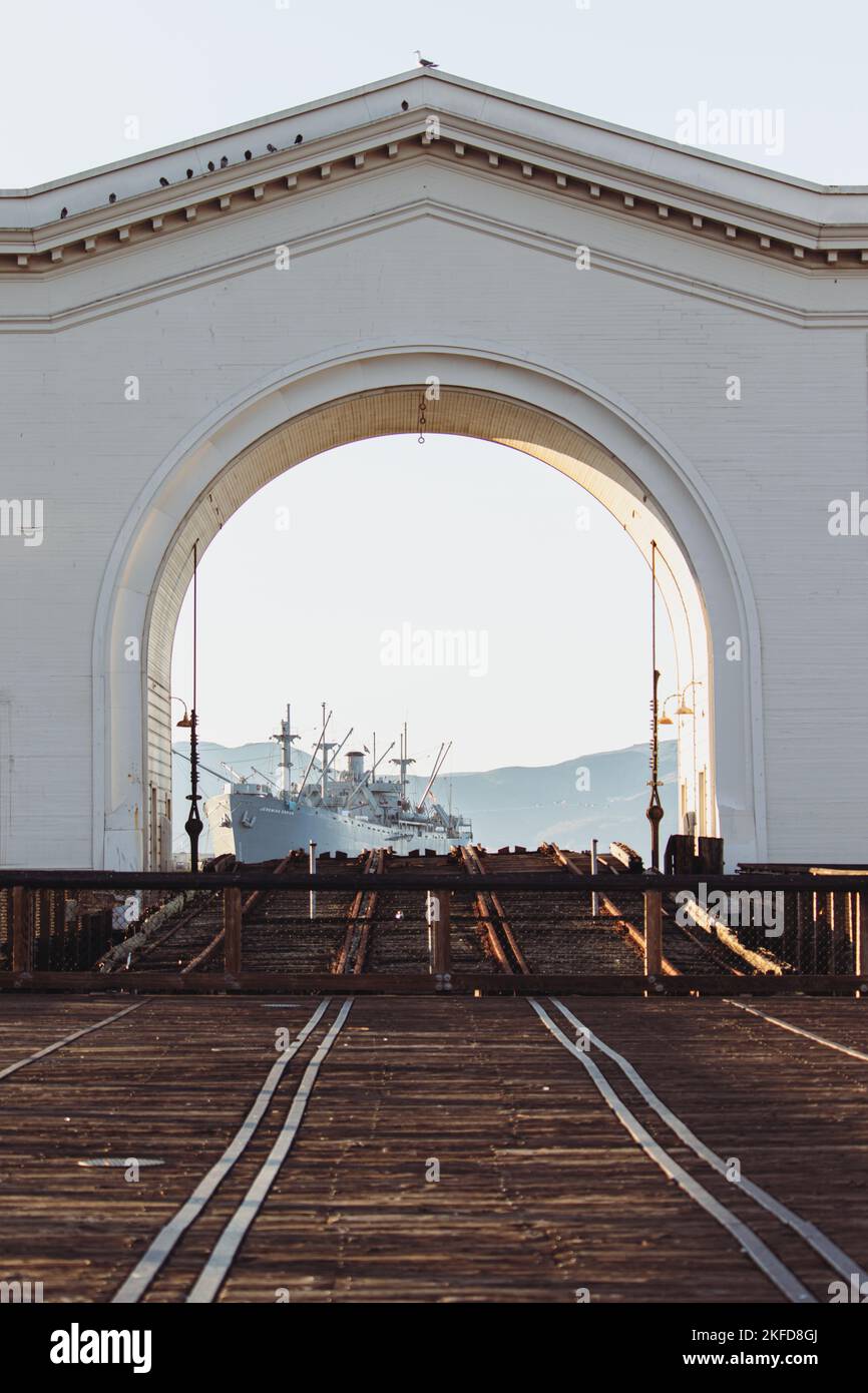 A view through the Pier 43 arch revealing SS Jeremiah O'Brien.  San Francisco, California, USA Stock Photo