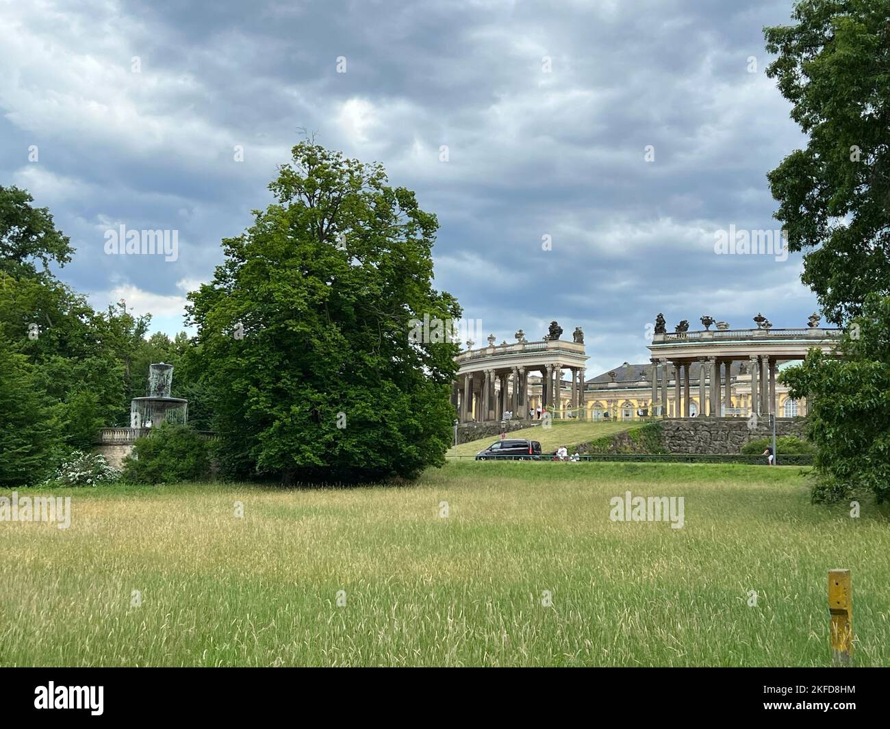 A grass field in front of the Sanssouci building in Potsdam