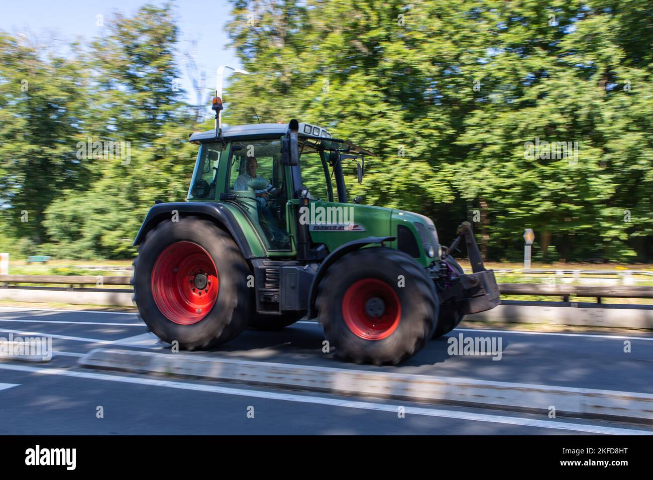 A farmer drives their tractors on their way to a protest in Ede