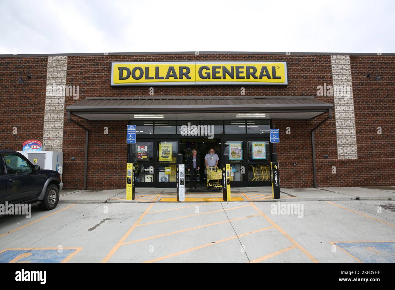 The customers exiting Dollar General with carts full of items Stock