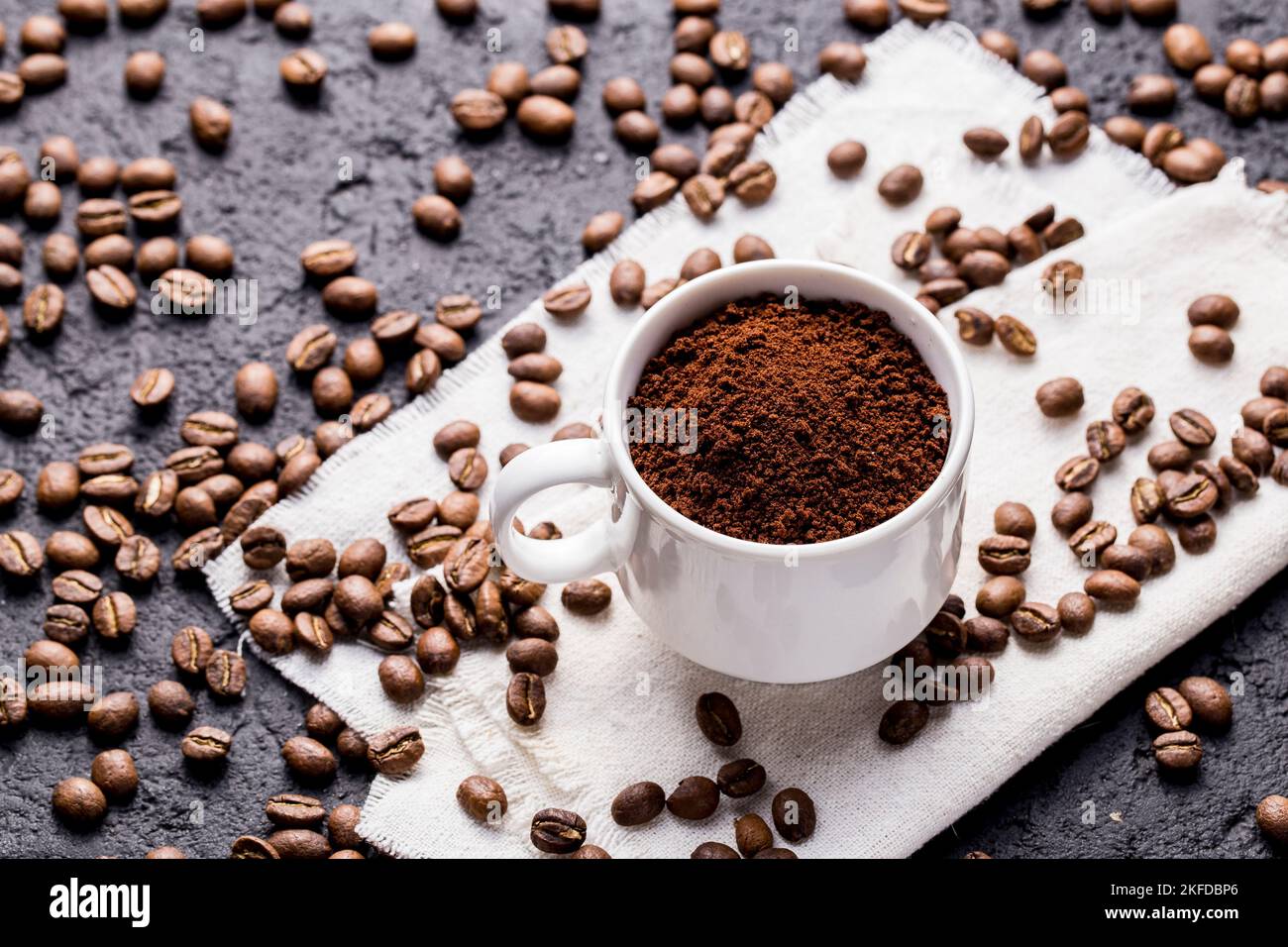 Roasted coffee beans and ground coffee, on dark background, closeup ...
