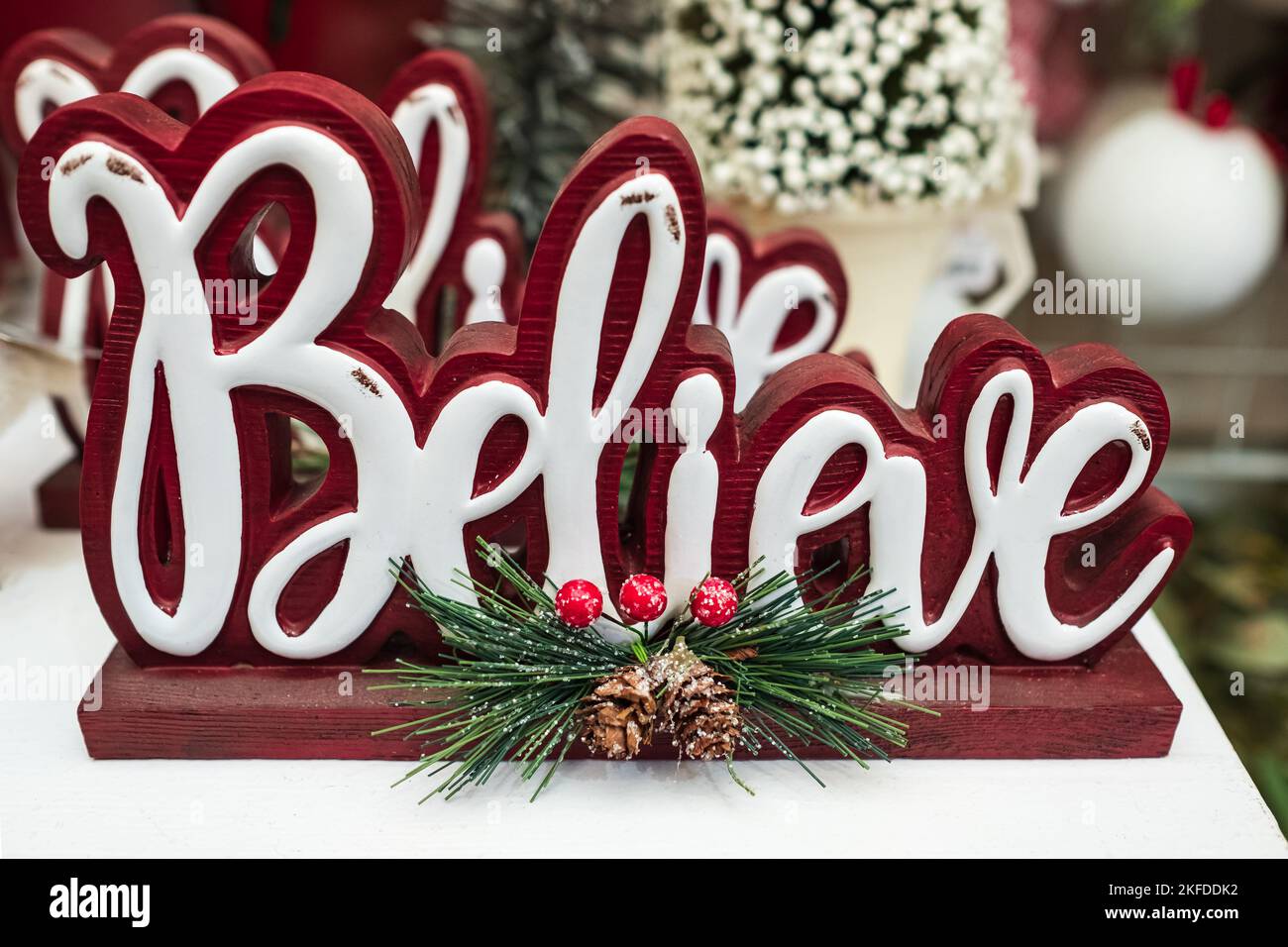 Believe word wooden Christmas decoration. Inspirational word BELIEVE with christmas decor. Nobody, selective focus Stock Photo