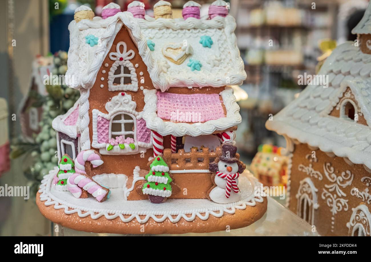 Christmas table setting with gingerbread house. Christmas morning. Wonderful holiday mood. Festive Christmas styling of homemade gingerbread house. No Stock Photo