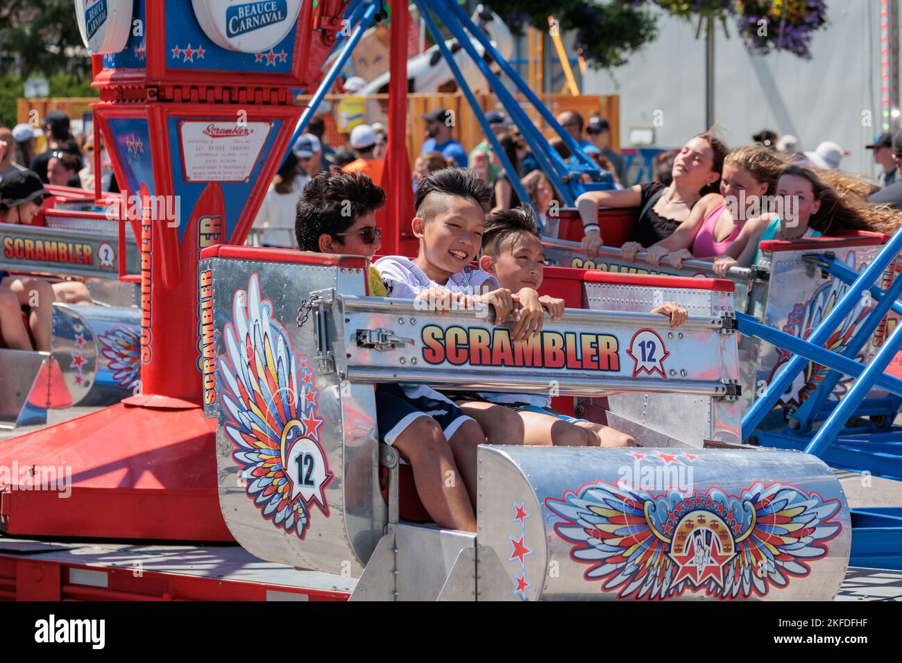 Fete Animation Rides Children celebrate Fete Nationale by enjoying the thrill rides at ...