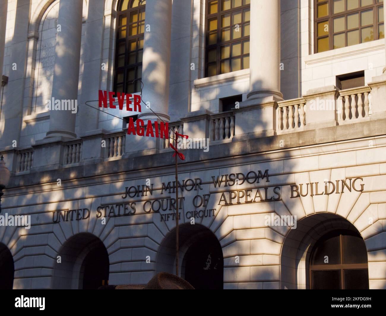 A protest sign of a wire hanger with the words Never Again at a pro-choice protest in New Orleans, USA Stock Photo