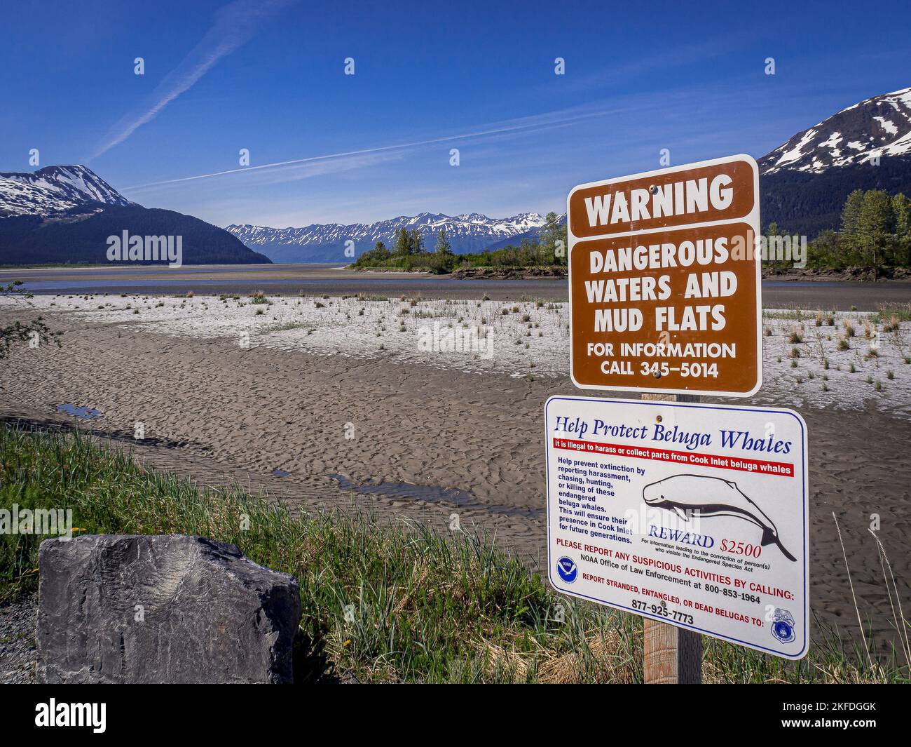 A view of a warning sign of dangerous water and mud flats with mountains in  the background in Alaska Stock Photo - Alamy