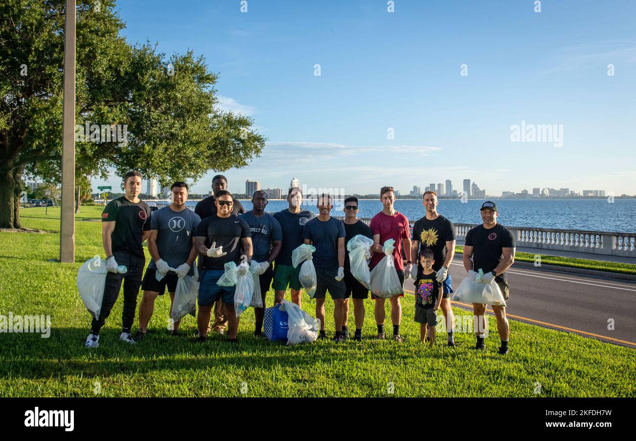 Servicemembers assigned to Joint Communications Support Element pose for a photo after clearing debris along Bayshore Boulevard in Tampa, Florida, Sept. 9, 2022. The group of Sailors, Airmen and Soldiers volunteer monthly to maintain the roadway as part of the Petty Officer’s Association. Group representatives shared that the team enjoys giving back to the community and keeping Tampa beautiful. Stock Photo