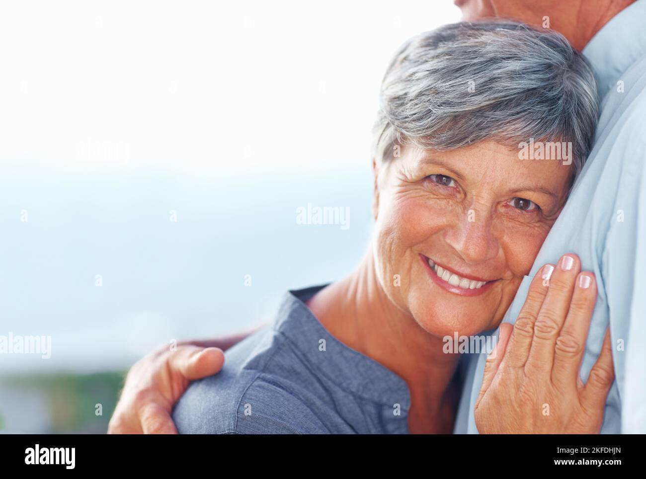 Mature woman resting head on mans chest. Portrait of smiling mature