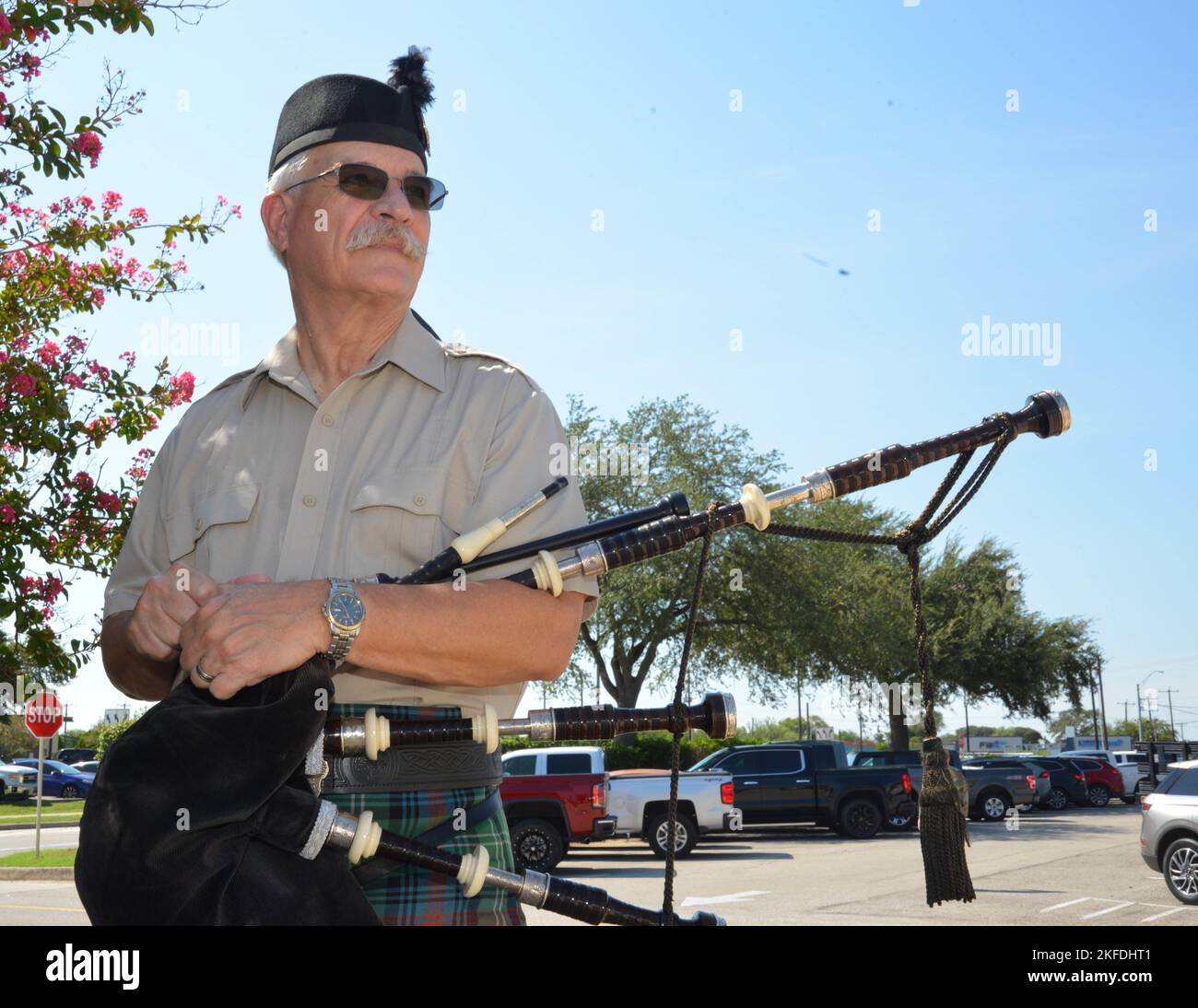 A ceremonial Bagpiper stands ready to play Amazing Grace during the