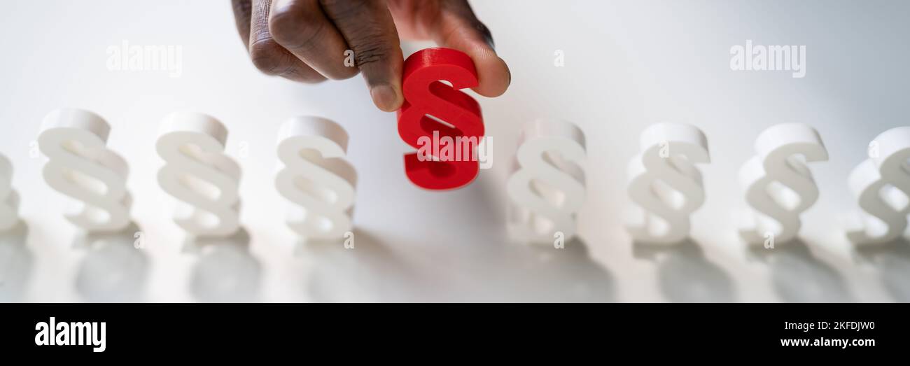 Businessperson's Hand Holding Paragraph Symbol. Legal Court Stock Photo