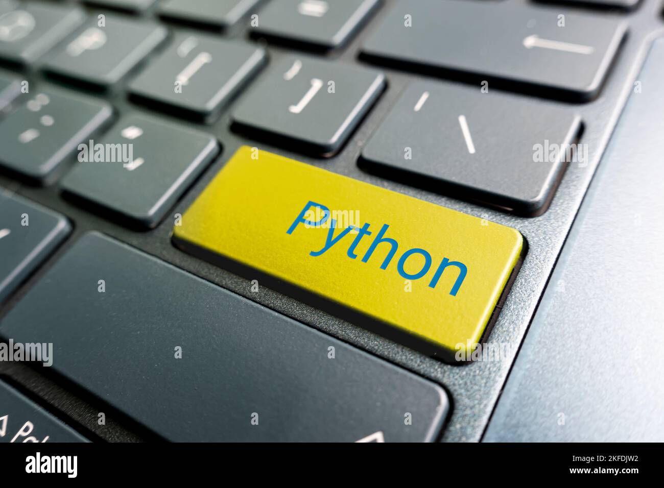 button with the python on the yellow keyboard of a modern laptop Stock ...
